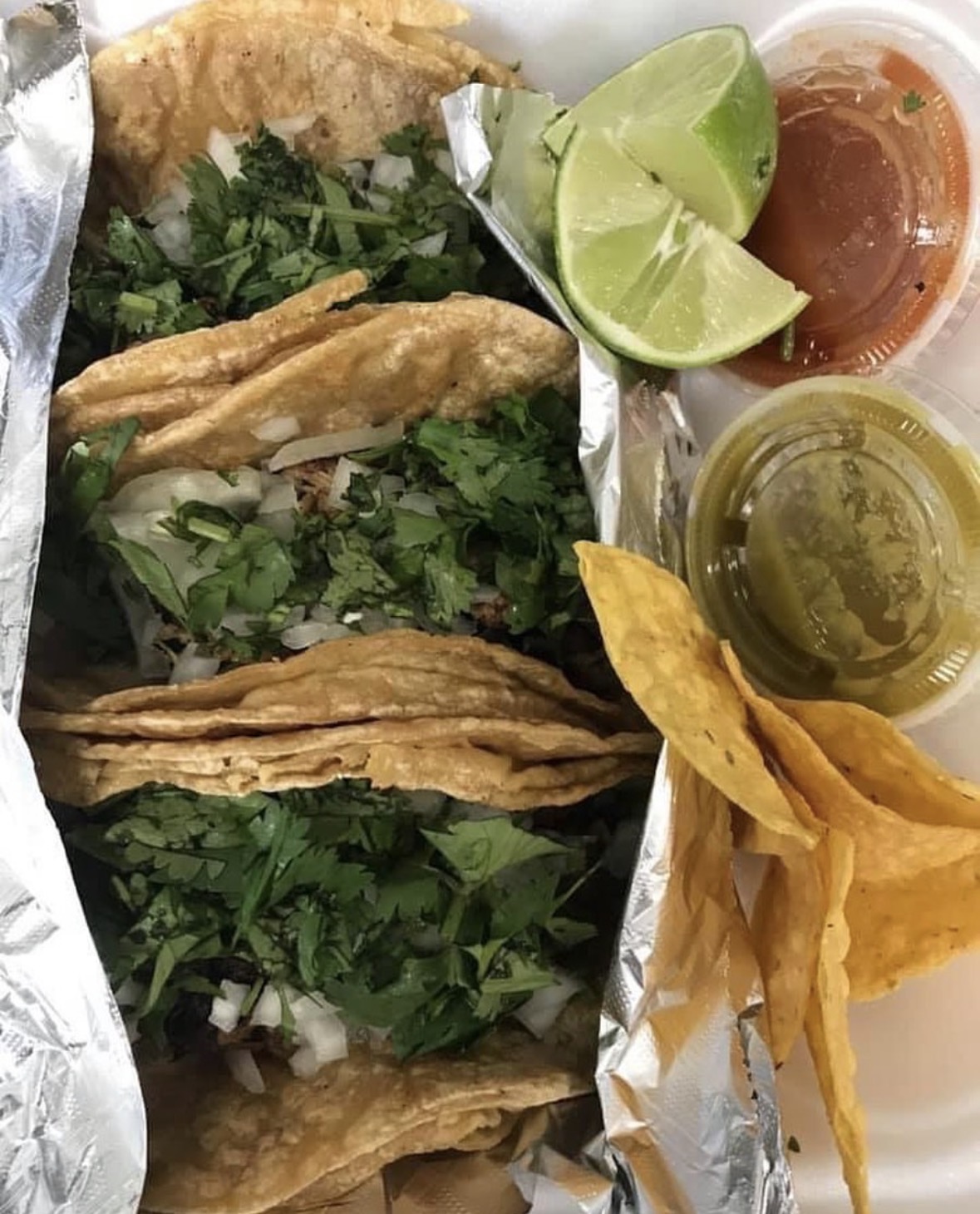 Street-style tacos with cilantro, onion, lime and house salsas